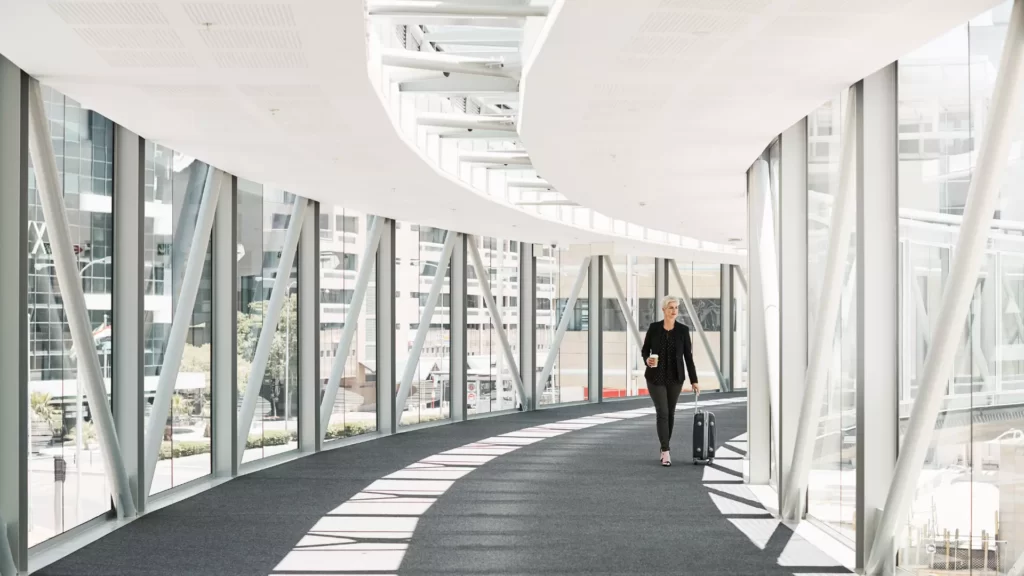 10 Ways to Position Yourself for a Job Promotion with a woman walking in office building